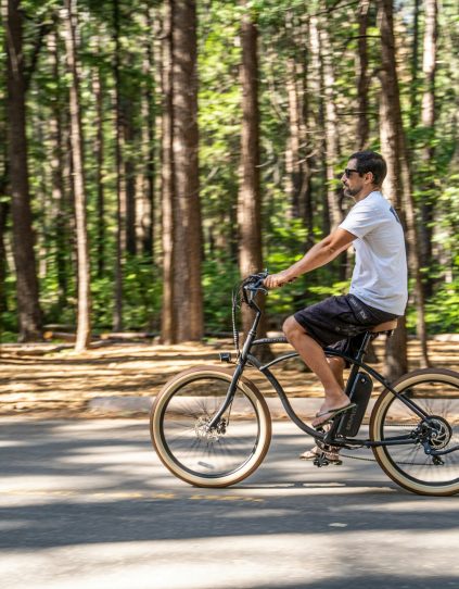 man riding bike in woods